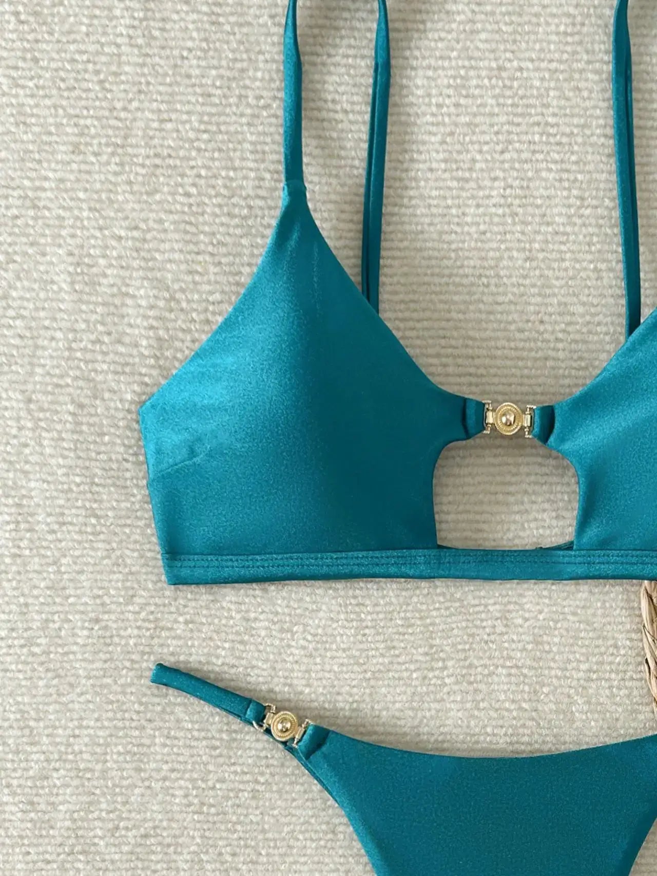 Turquoise two-piece bikini set with push-up triangle top and Brazilian cheeky bottom, featuring gold ring hardware.