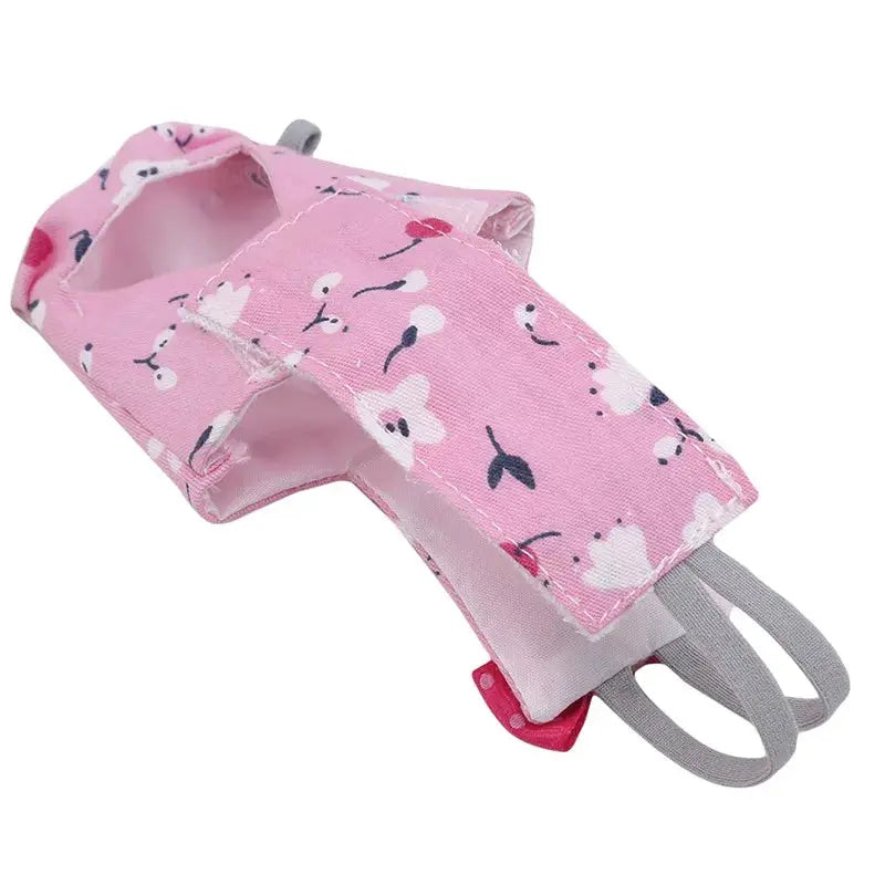 Parrot diaper flight suit in pink floral fabric with gray elastic straps for small to large pet birds; washable by Simples Market.