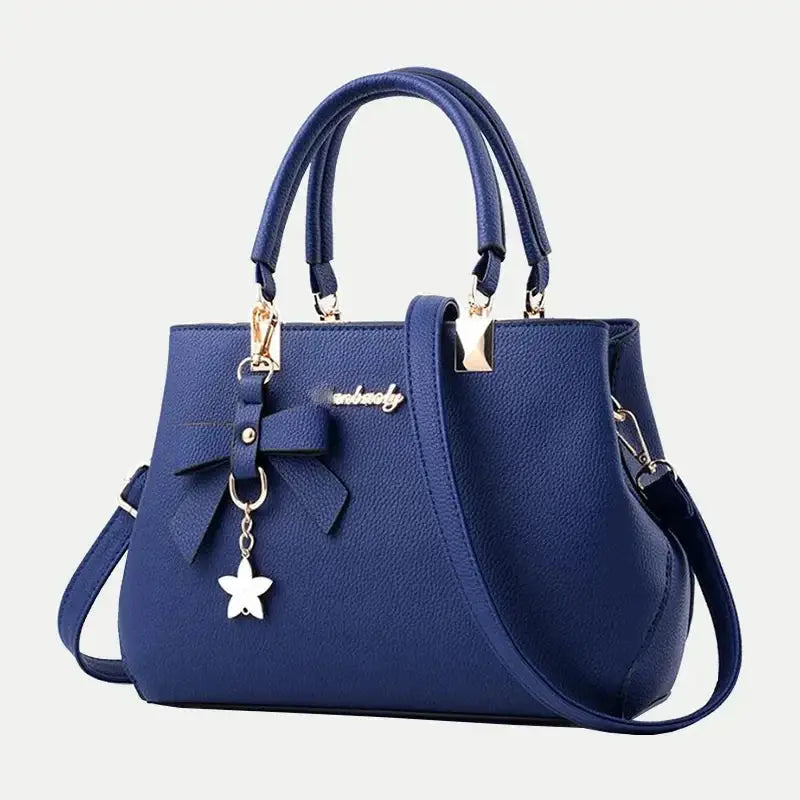 Blue Simples Market shoulder bag with bowknot charm, gold-tone hardware and top handles