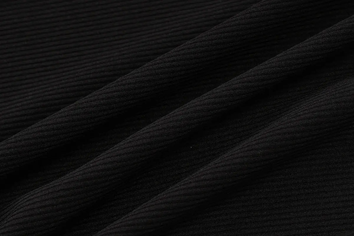 Jumpsuit fabric: ribbed black material close-up texture