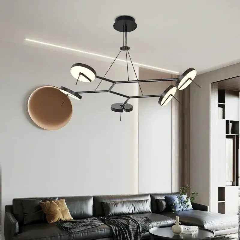 Creative LED Chandelier by Simples Market, black lustre, adjustable hanging lamp with circular ring lights over sofa.