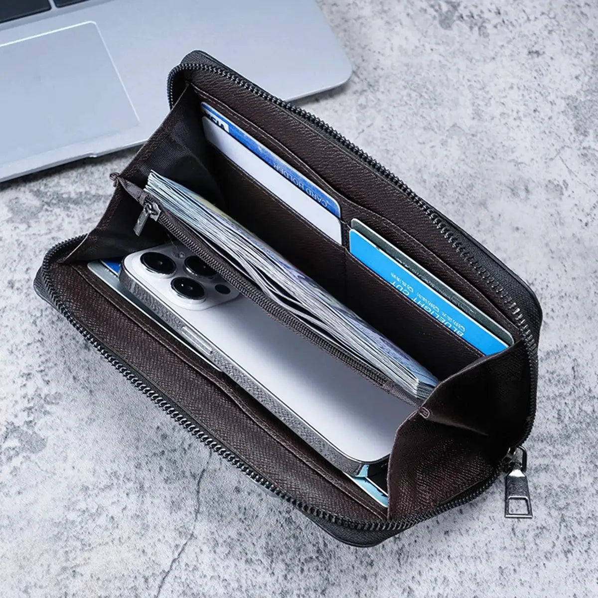 Simples Market brown long zippered wallet with multiple card slots and cash inside.