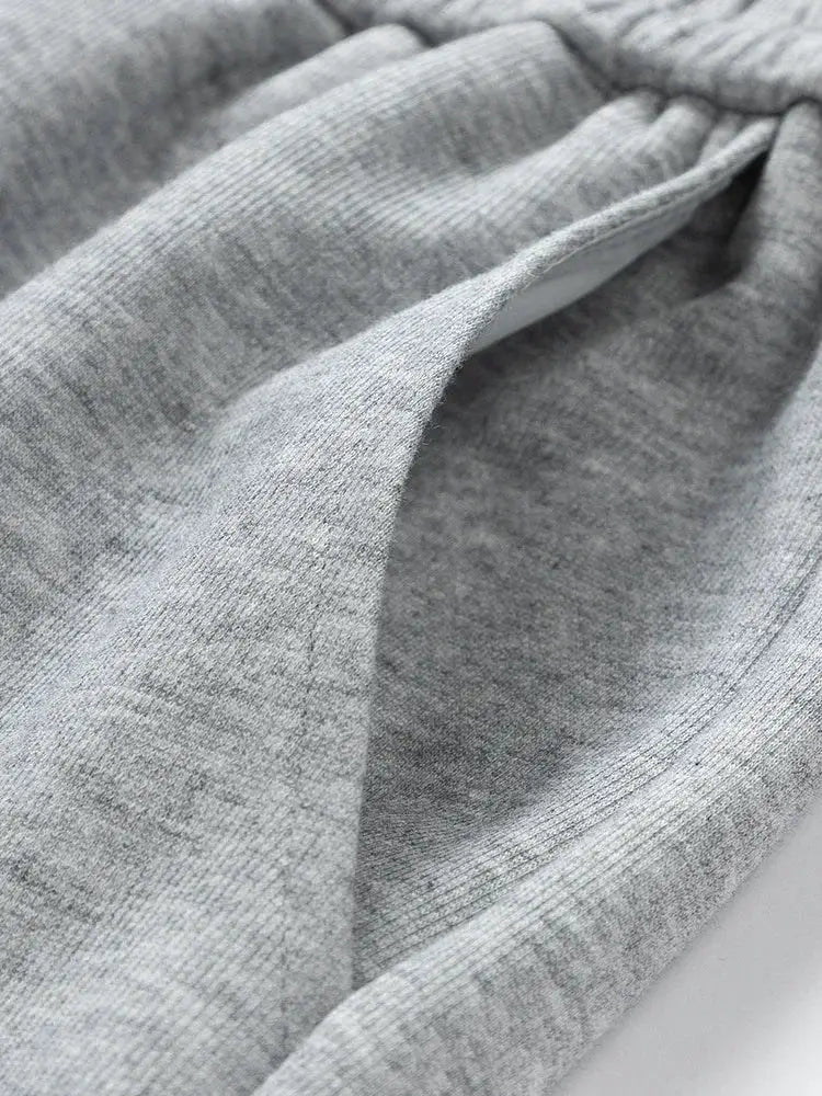Men's gray cotton sweatpants fabric close-up detail, soft knit texture