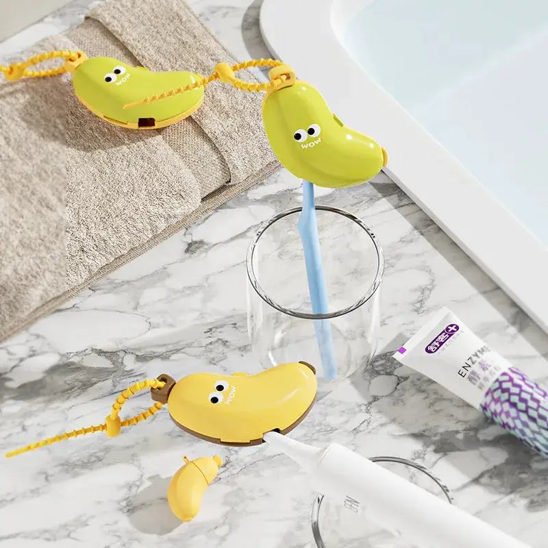Yellow banana-shaped toothbrush protective caps (2) with cords and toothpaste storage