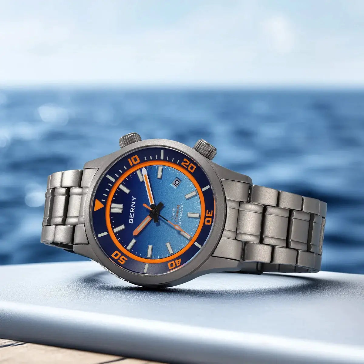 BERNY diver watch for men with blue dial, orange bezel, titanium case and metal bracelet; 20ATM automatic