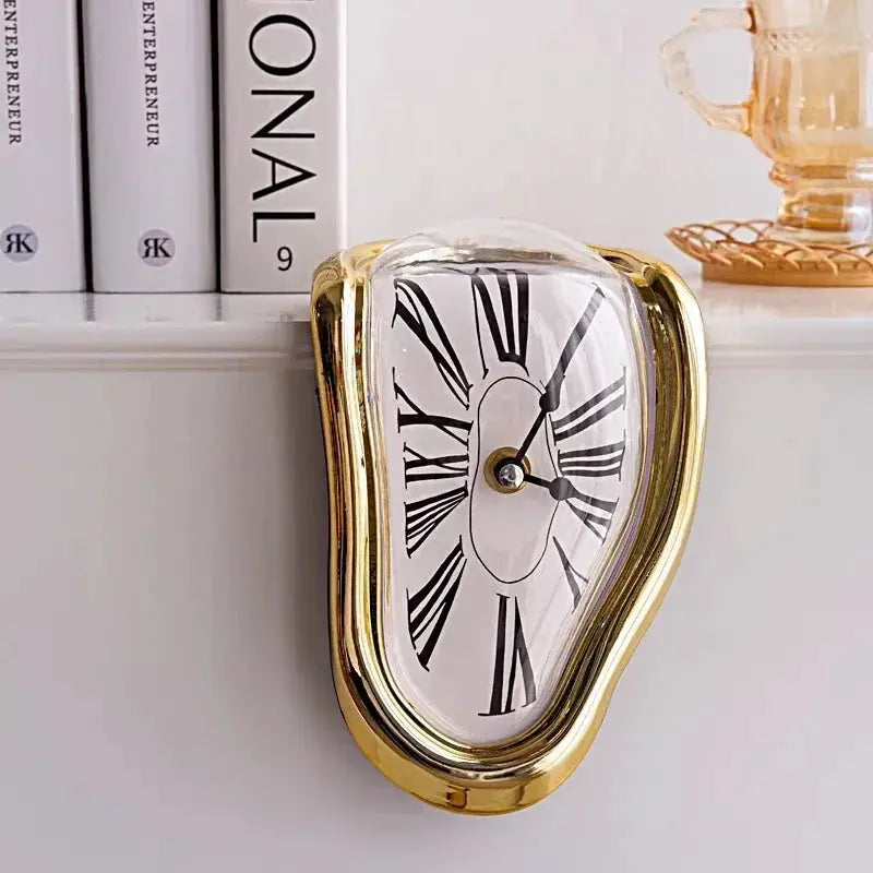 Surreal melted wall clock with a gold-tone frame, glass dome, and Roman numerals; decorative home or office shelf clock