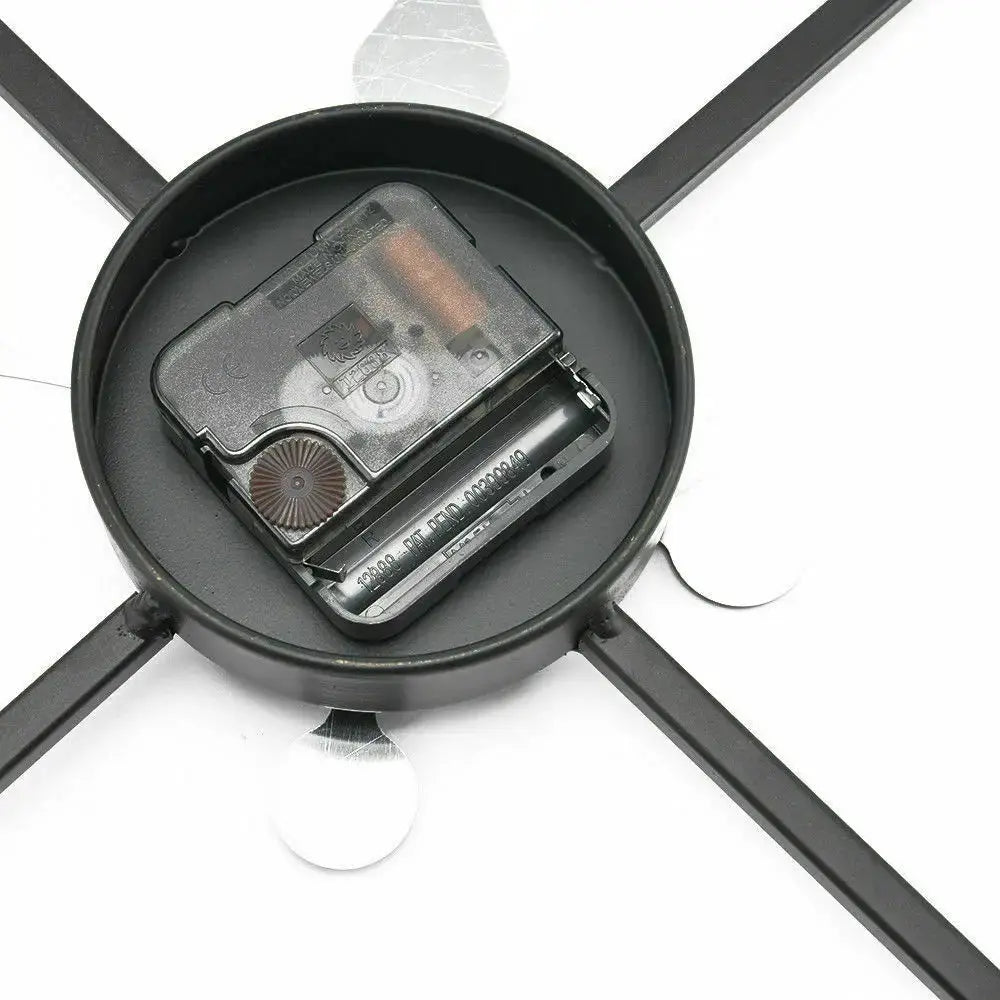 Round black metal wall clock back view with battery compartment and movement housing.