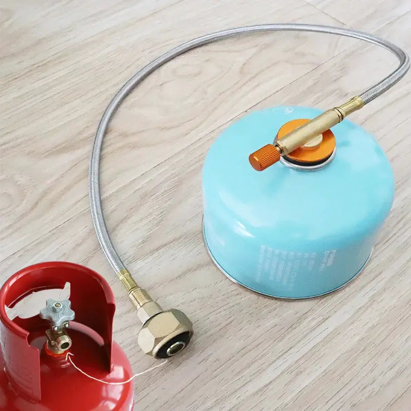 Camping gas refill adapter kit with blue canister, braided hose and brass fittings