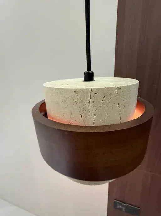 Japanese Wabi Sabi pendant lamp by Simples Market; beige concrete cylinder with dark wood ring, warm glow.