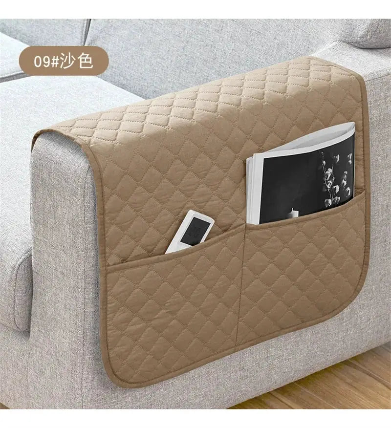 Sofa armrest slipcover with pockets in beige quilted fabric, holding a remote and magazine.