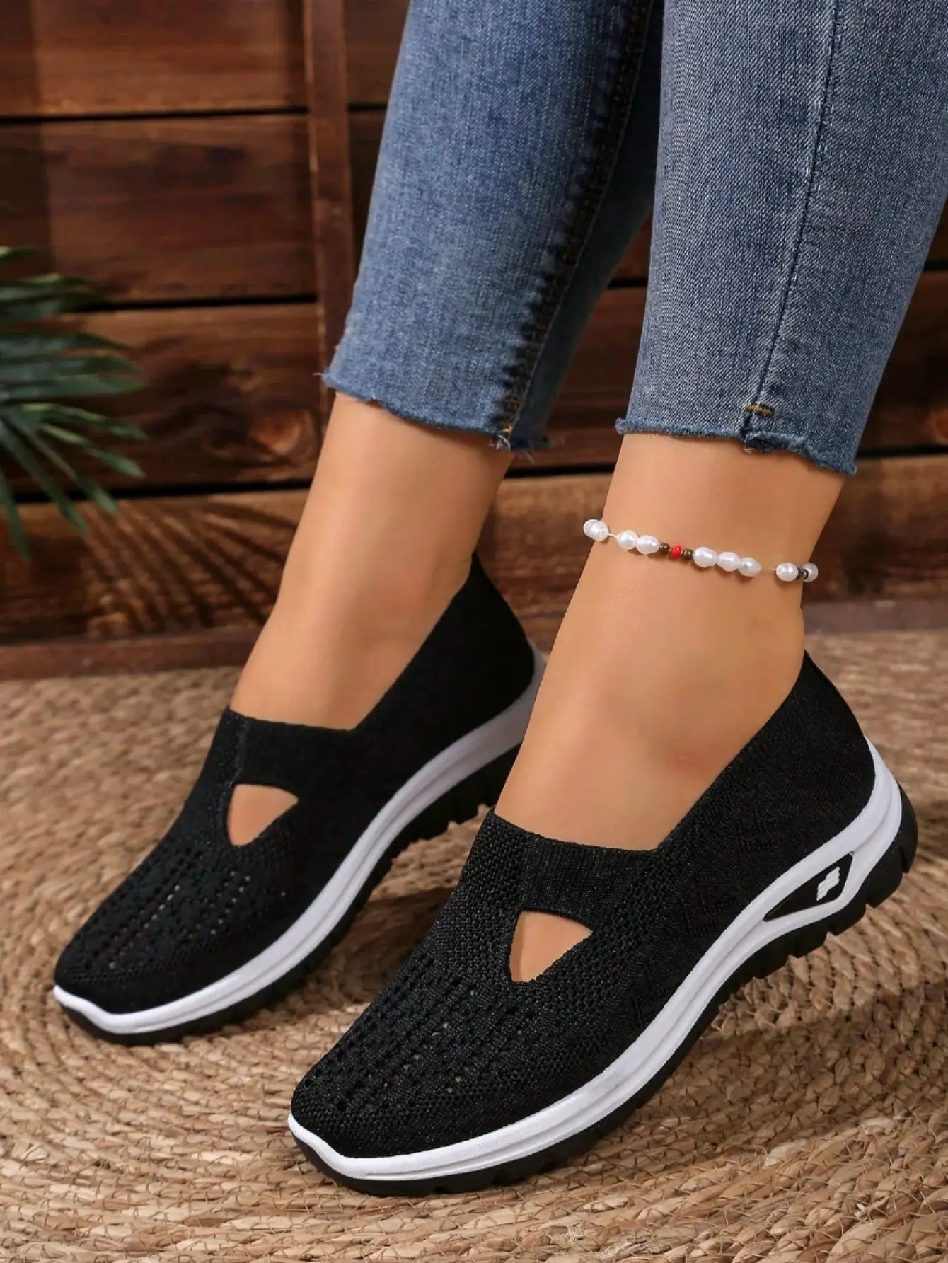 Women's casual mesh sneakers with cut-out T-strap, black knit upper and cushioned wedge sole