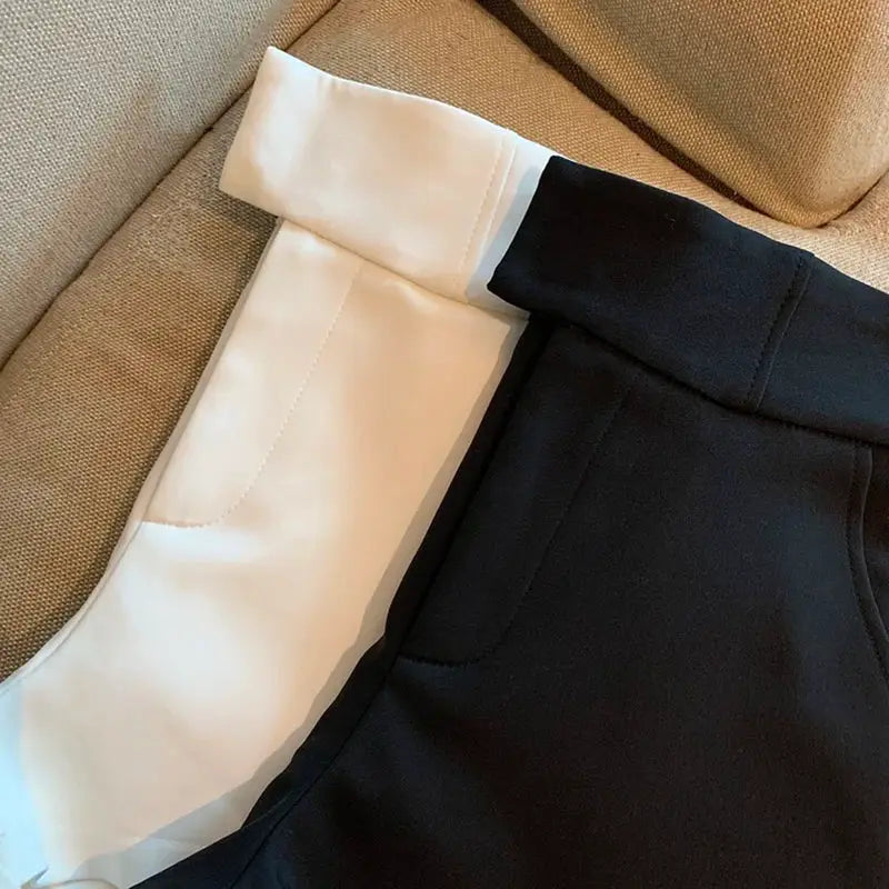 Women's shorts by Simples Market, black with white side panels, high-waisted A-line design