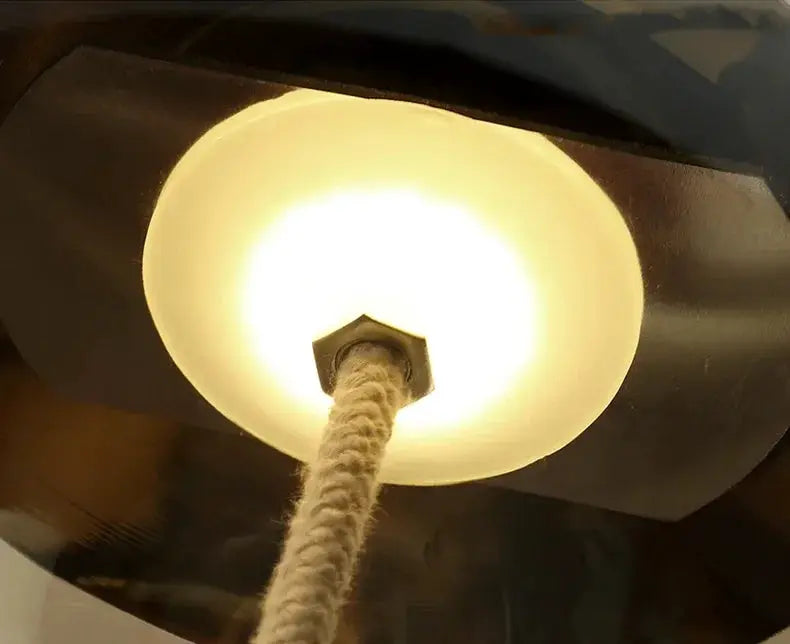 Beige hemp-rope pendant lamp with warm LED glass shade; close-up canopy and cord.