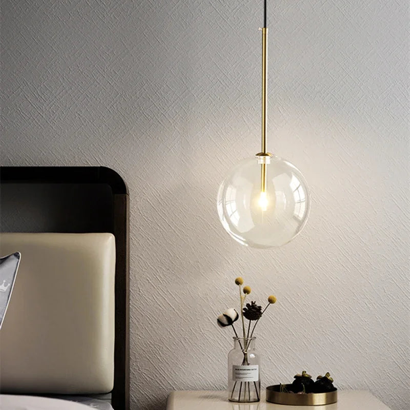 Modern LED pendant lamp with glass globe and gold suspension rod for bedroom decor