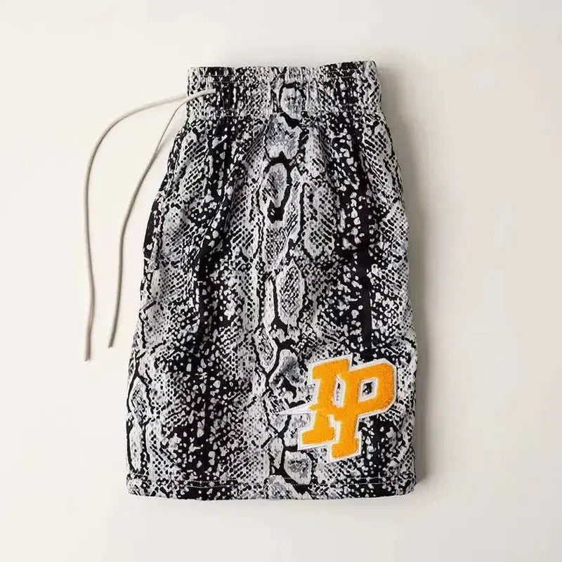 Men's IP Trend snakeskin-print quick-dry shorts with yellow IP logo; breathable mesh fabric.