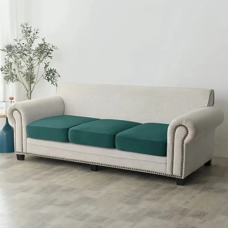 Beige plush sofa slipcover on a three-seat sofa with teal seat cushions; anti-slip elastic.