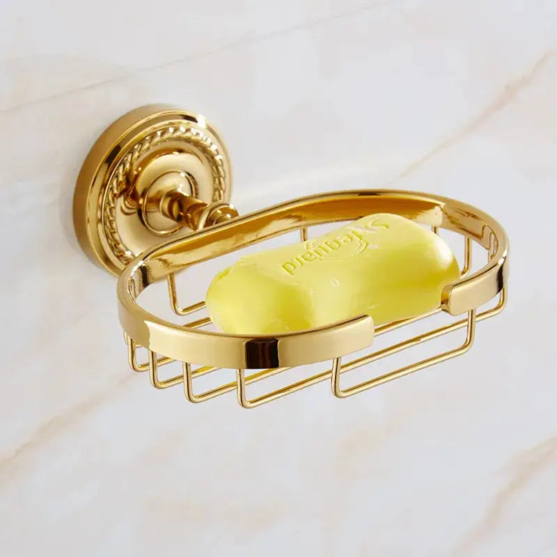 Soap dish basket in gold brass, wall-mounted, with soap bar.