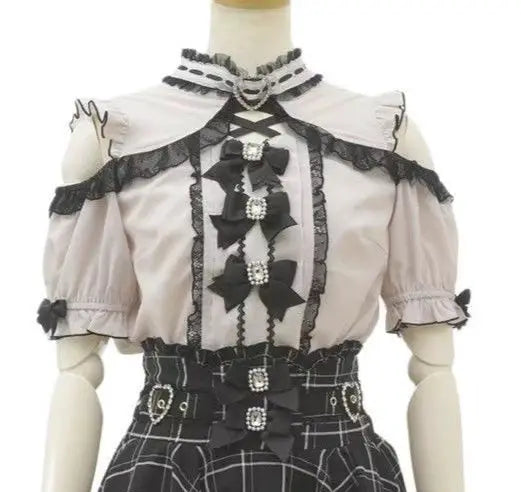 Pink Lolita blouse and plaid skirt set with off-shoulder neckline, black lace trim, bow accents, and pearl details.