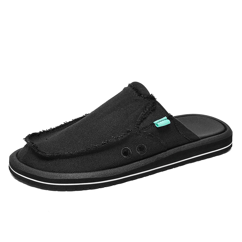 Men's black canvas slip-on loafer with frayed edges and teal tab, white-stripe sole.
