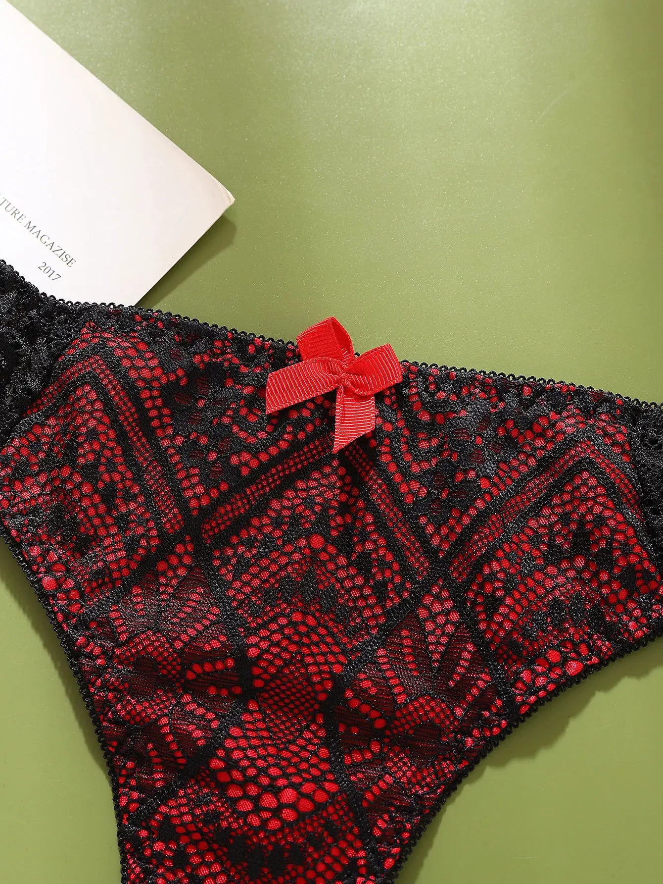 G-string panty by Simples Market, black lace with red pattern and red bow