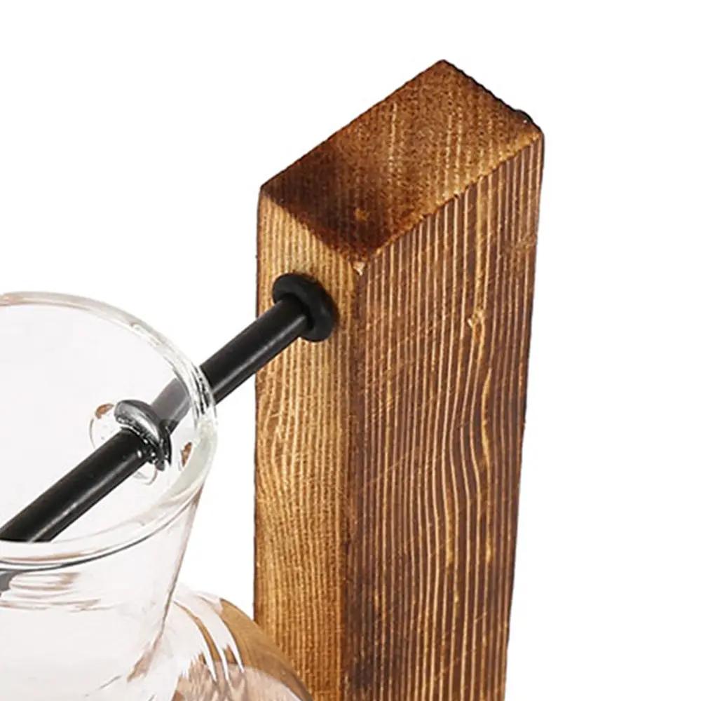 Creative glass desktop planter bulb vase on a brown wooden stand for home decor