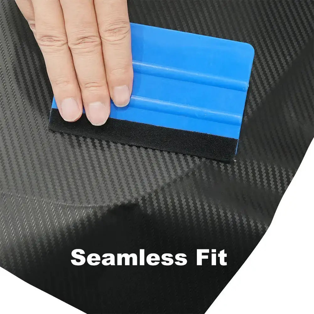 3D carbon fiber black vinyl wrap sheet being applied with a blue scraper; seamless fit.