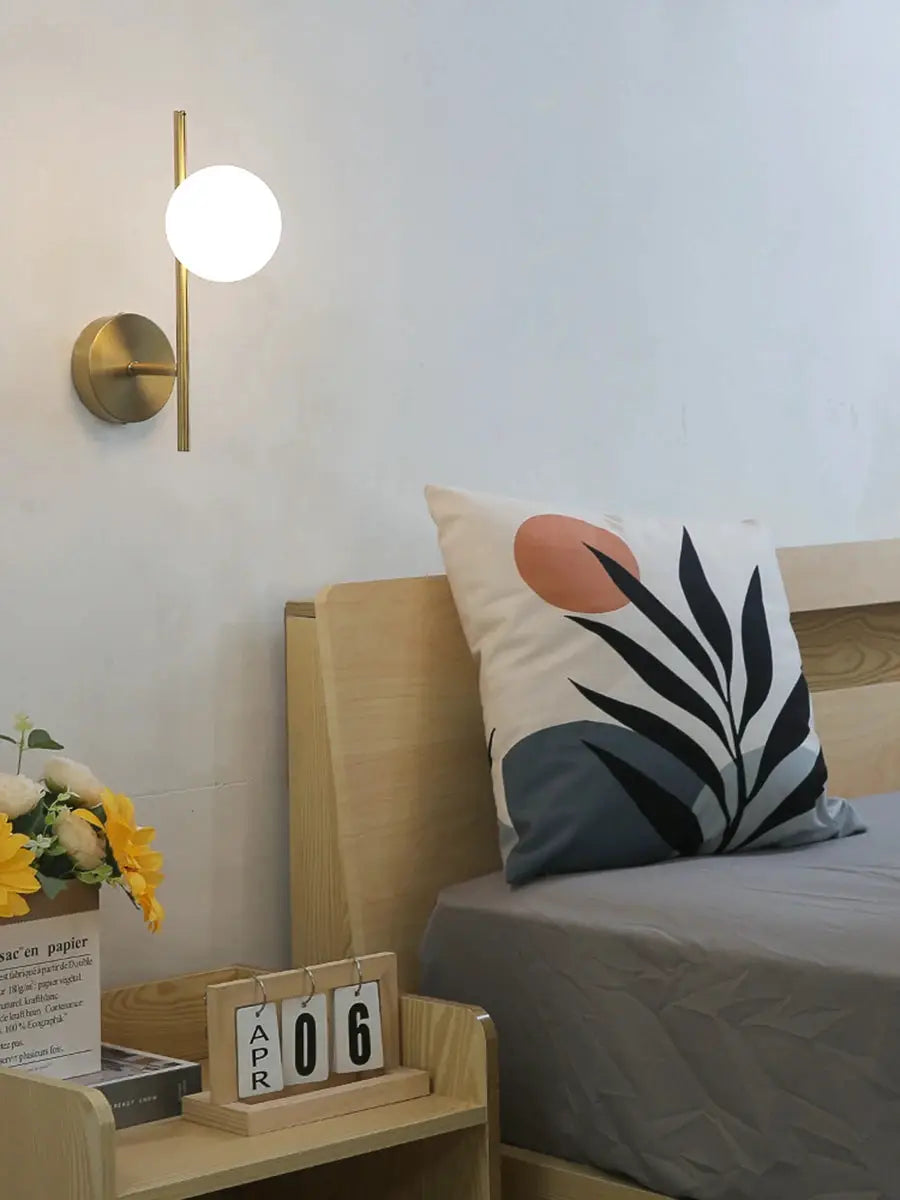 Modern LED wall lamp in brass gold finish with milky glass round globe, bedside wall light