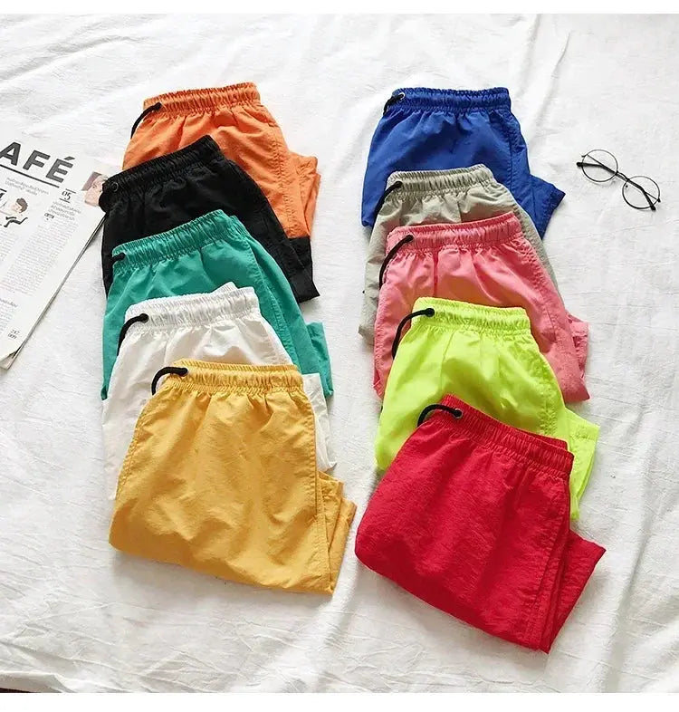 Men's swim shorts in assorted colors, lightweight board shorts for beach and swimming.