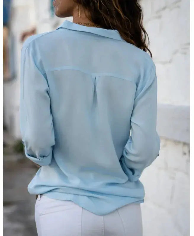 Women's light blue button-up blouse with loose fit, back yoke seam and long sleeves