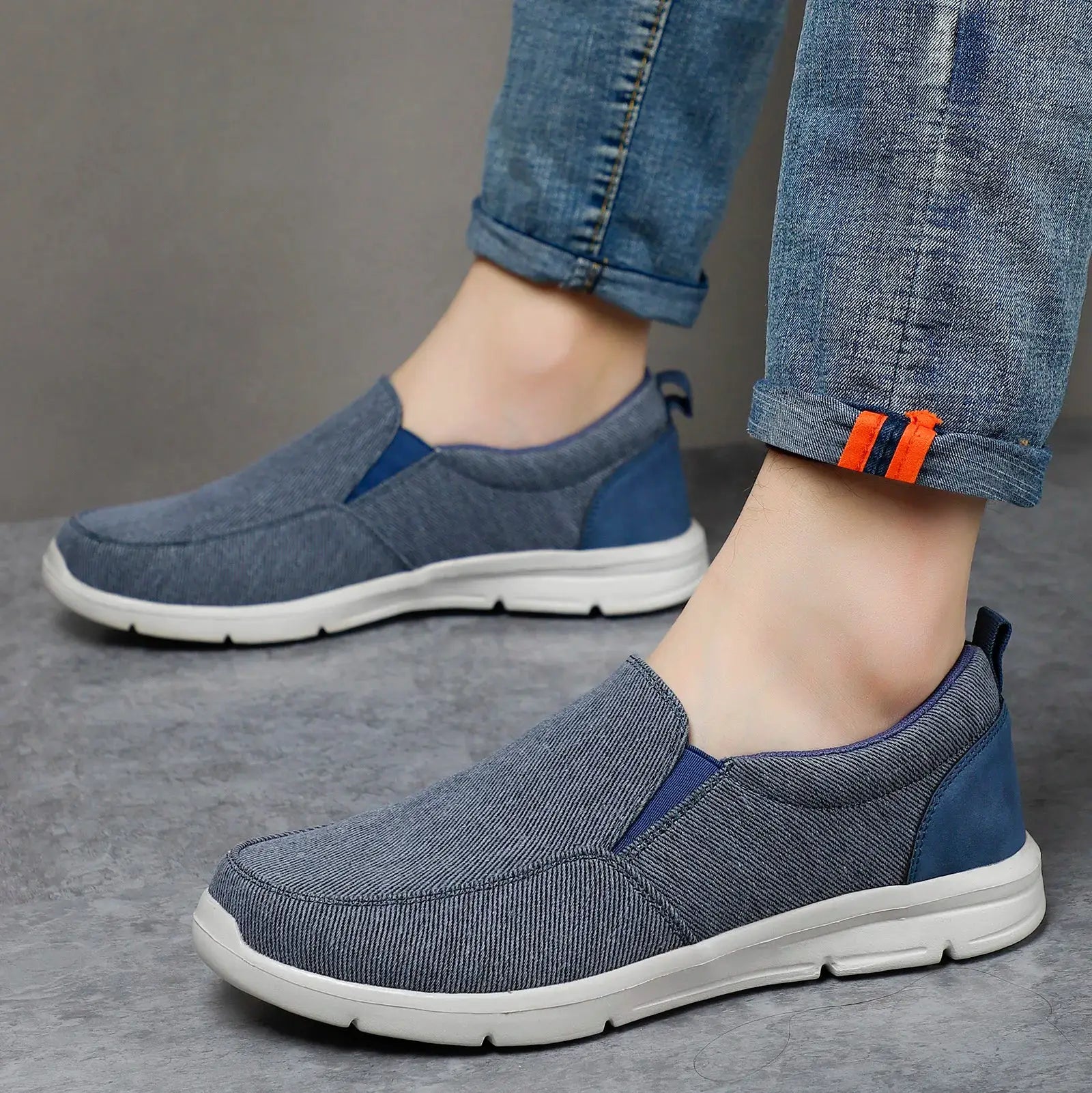 Men's blue canvas slip-on walking sneakers with white sole