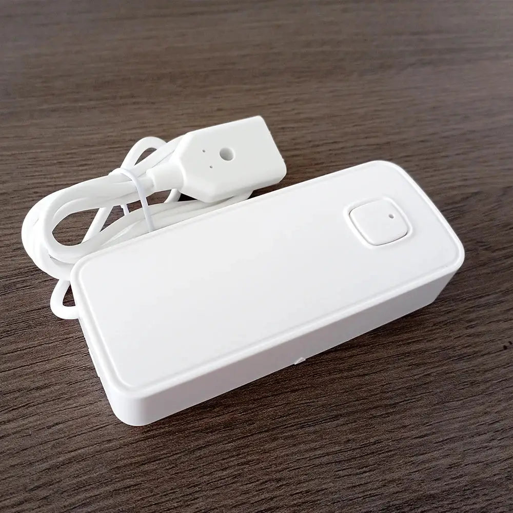 Tuya Smart flood leakage sensor: white rectangular control unit with top square button and attached power cord
