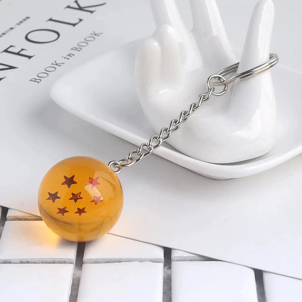 Dragon Ball keychain with orange bead pendant featuring star patterns, metal chain and ring from Simples Market