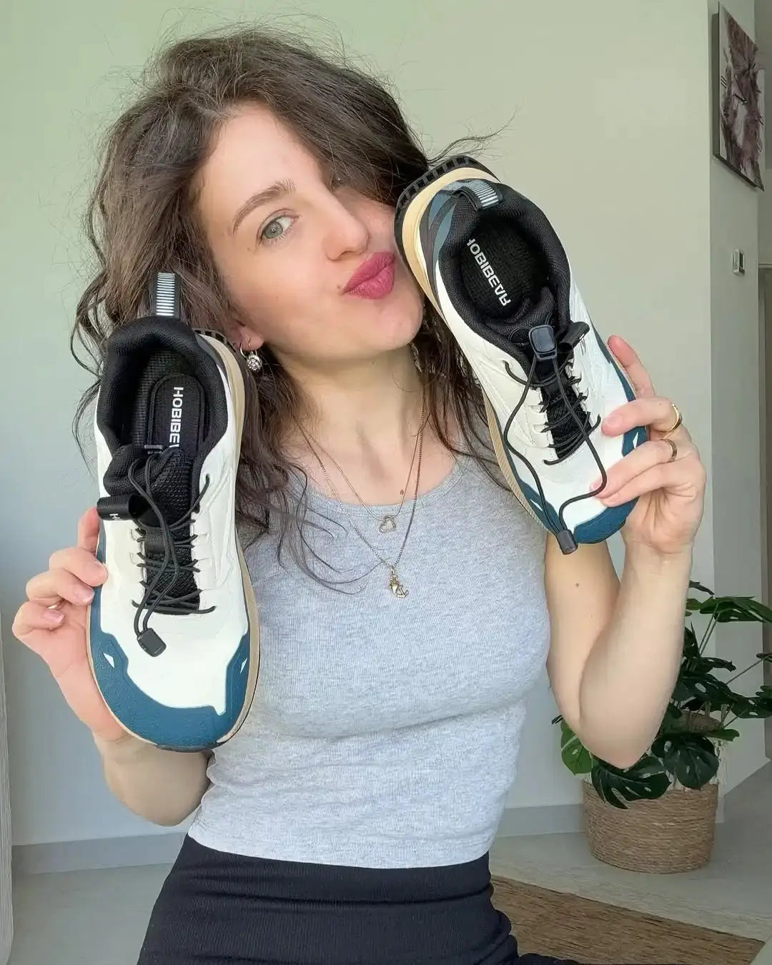HOBIBEAR unisex running shoes are lightweight white sneakers with blue accents and elastic-lace design.