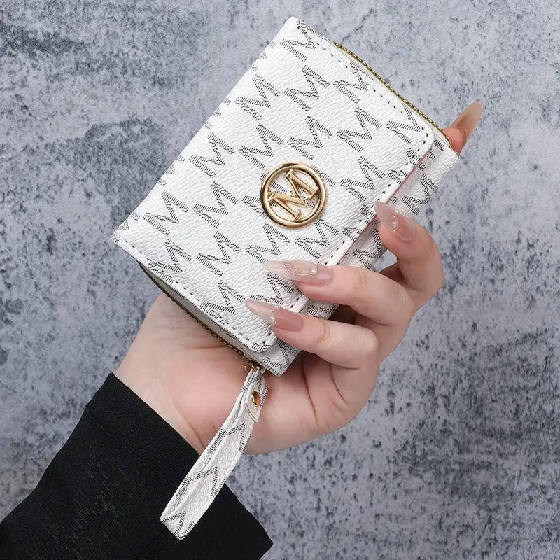 Women's wallet by Simples Market; white PU with gray printed pattern, gold circular logo, wrist strap.