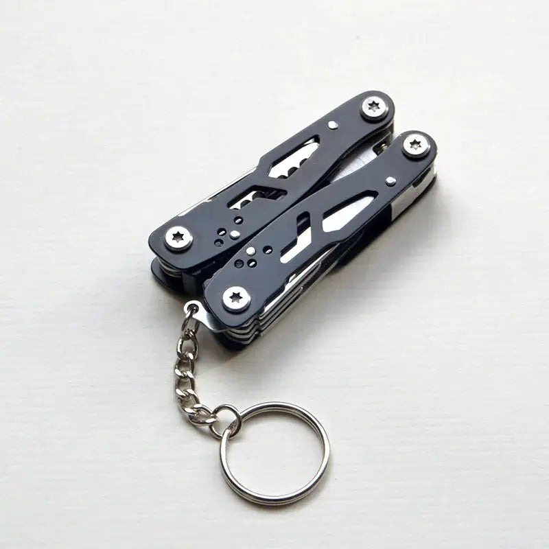 Simples Market outdoor survival folding multi-tool with black skeletonized body and keyring chain