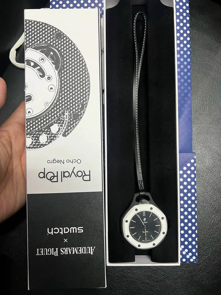 AP Swatch Royal Oak replica watch with black dial, white bezel, black strap in gift box