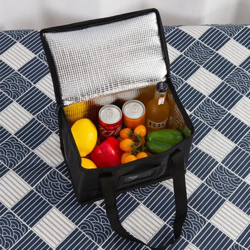 Simples Market insulated delivery bag, black cooler with reflective interior, opened to show drinks and peppers.