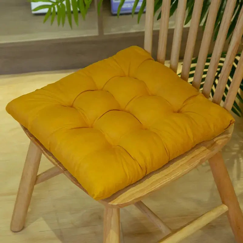 Chair pad cushion mustard yellow tufted fabric on a wooden chair