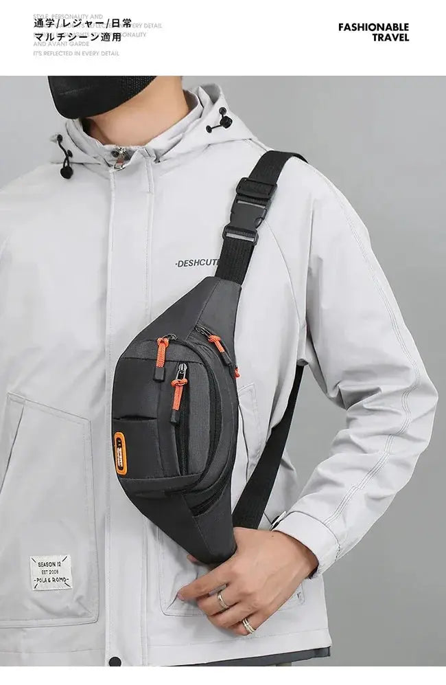 Simples Market Oxford waterproof waist bag in black with orange zipper pulls, worn across the torso.