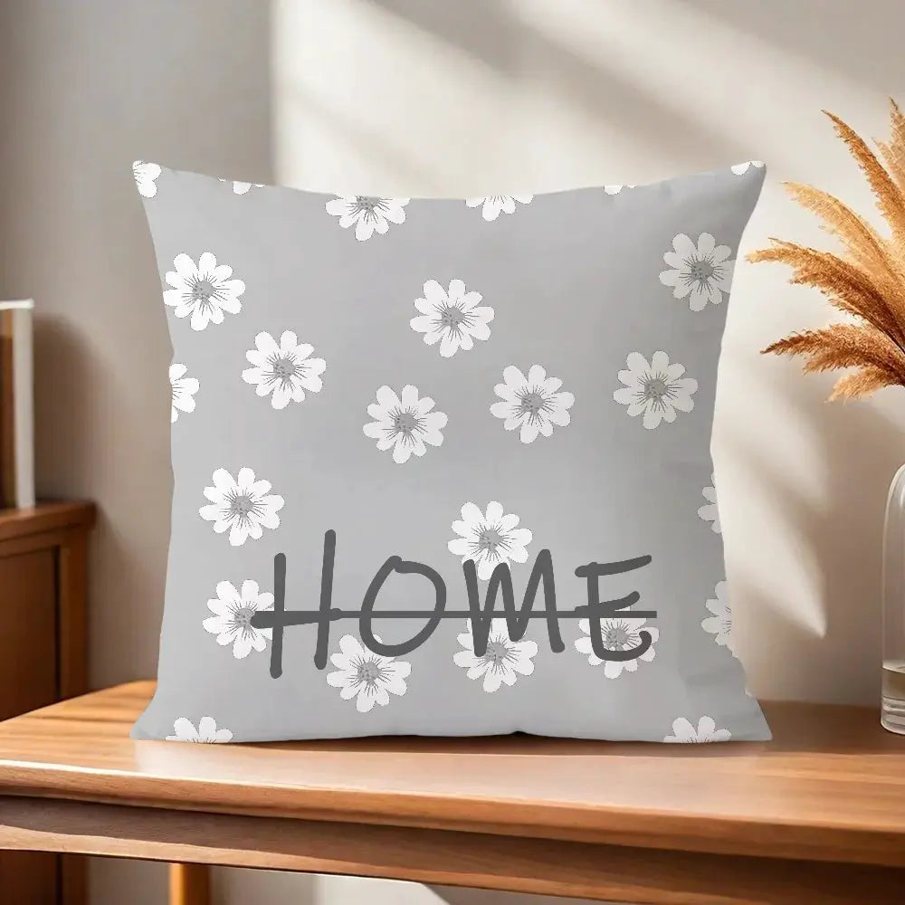 Gray pillow cover with white floral pattern and bold HOME graphic.