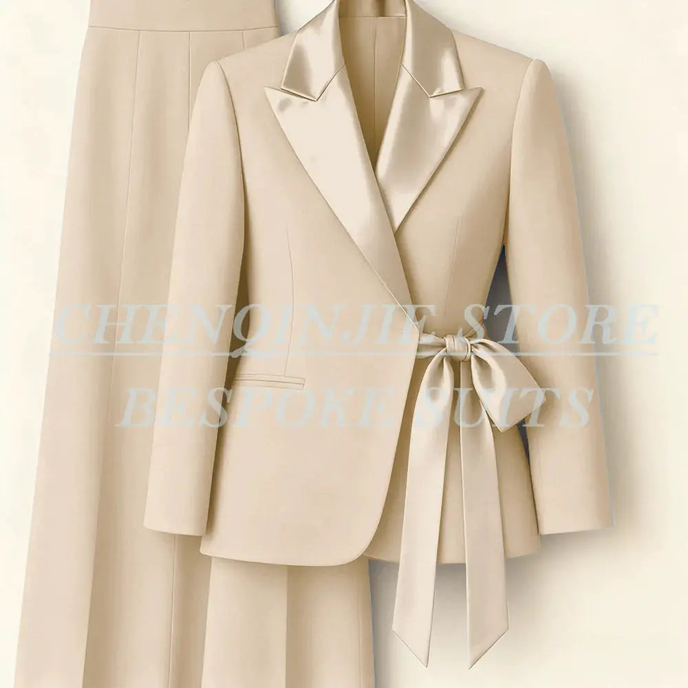 Beige women's two-piece blazer and pants suit with peak lapel and waist belt by Simples Market