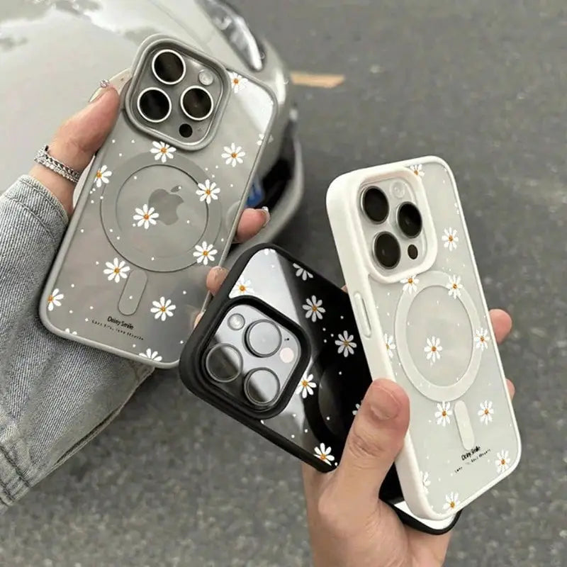 iPhone case set of three with daisy pattern for wireless charging; gray, white, and black variants by Simples Market