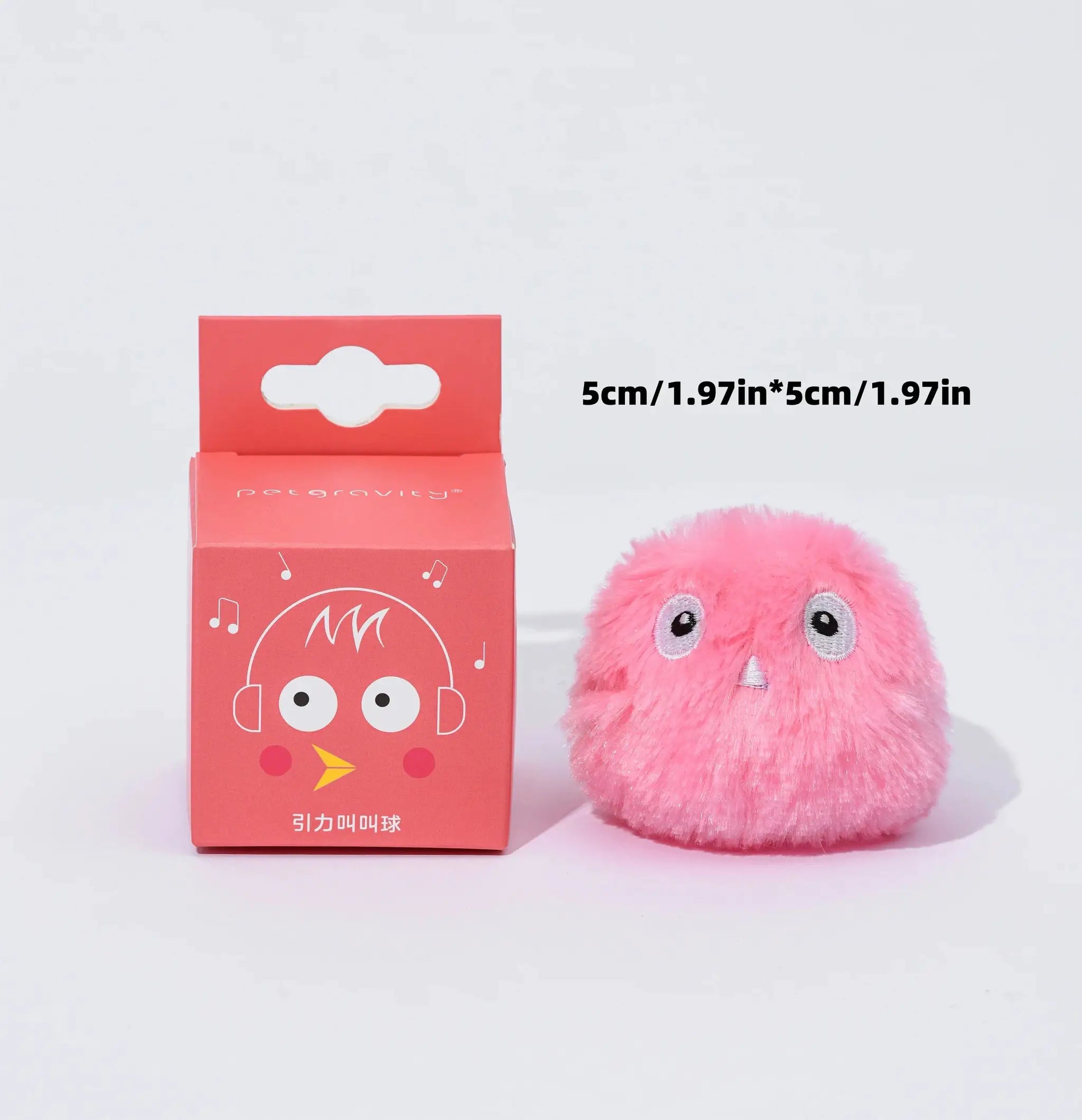 Pink fluffy interactive squeaky ball toy for cats and dogs beside two red boxes.