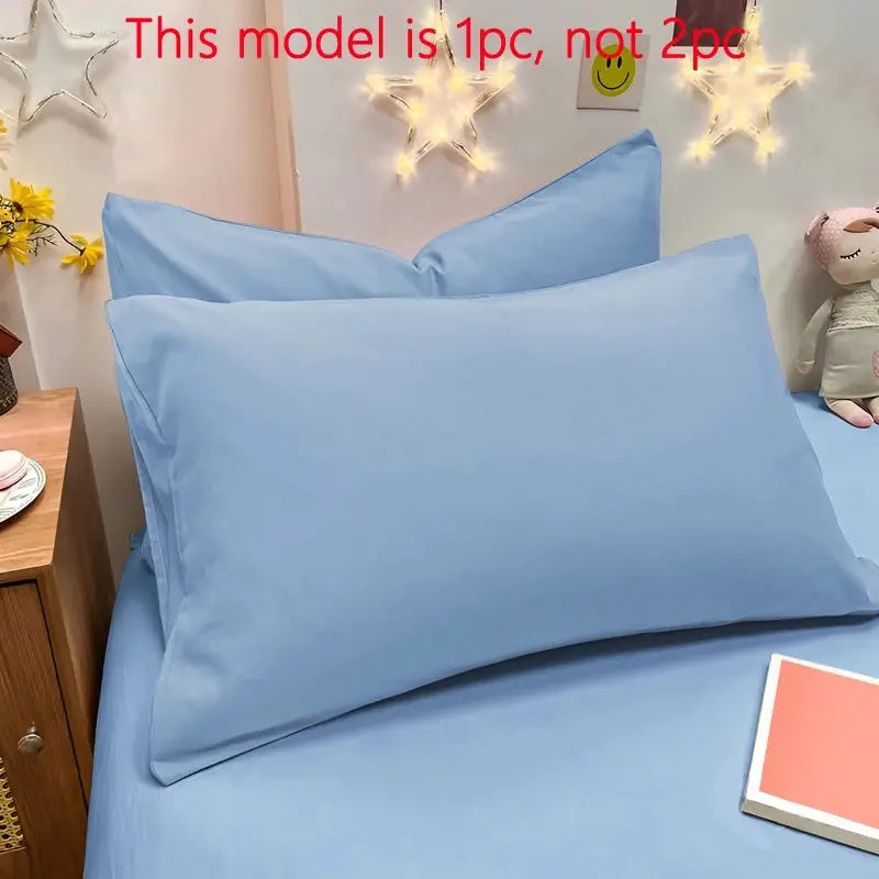 Simples Market blue matte solid color pillowcase on bed with pillows