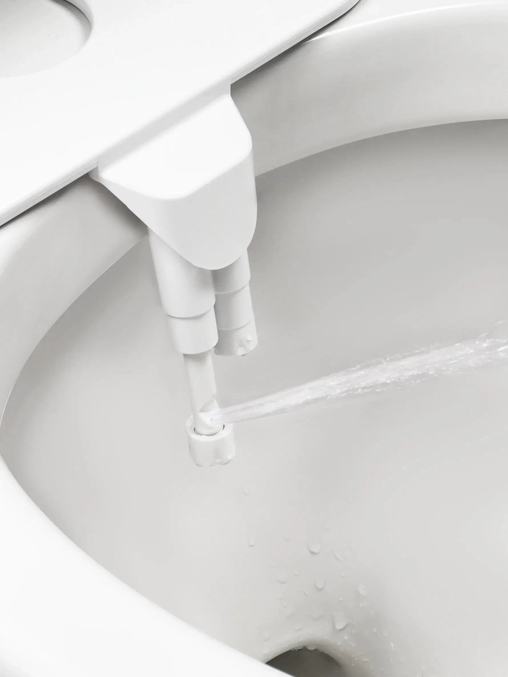 SAMODRA non-electric bidet attachment with dual nozzles (front and rear) on a white toilet seat