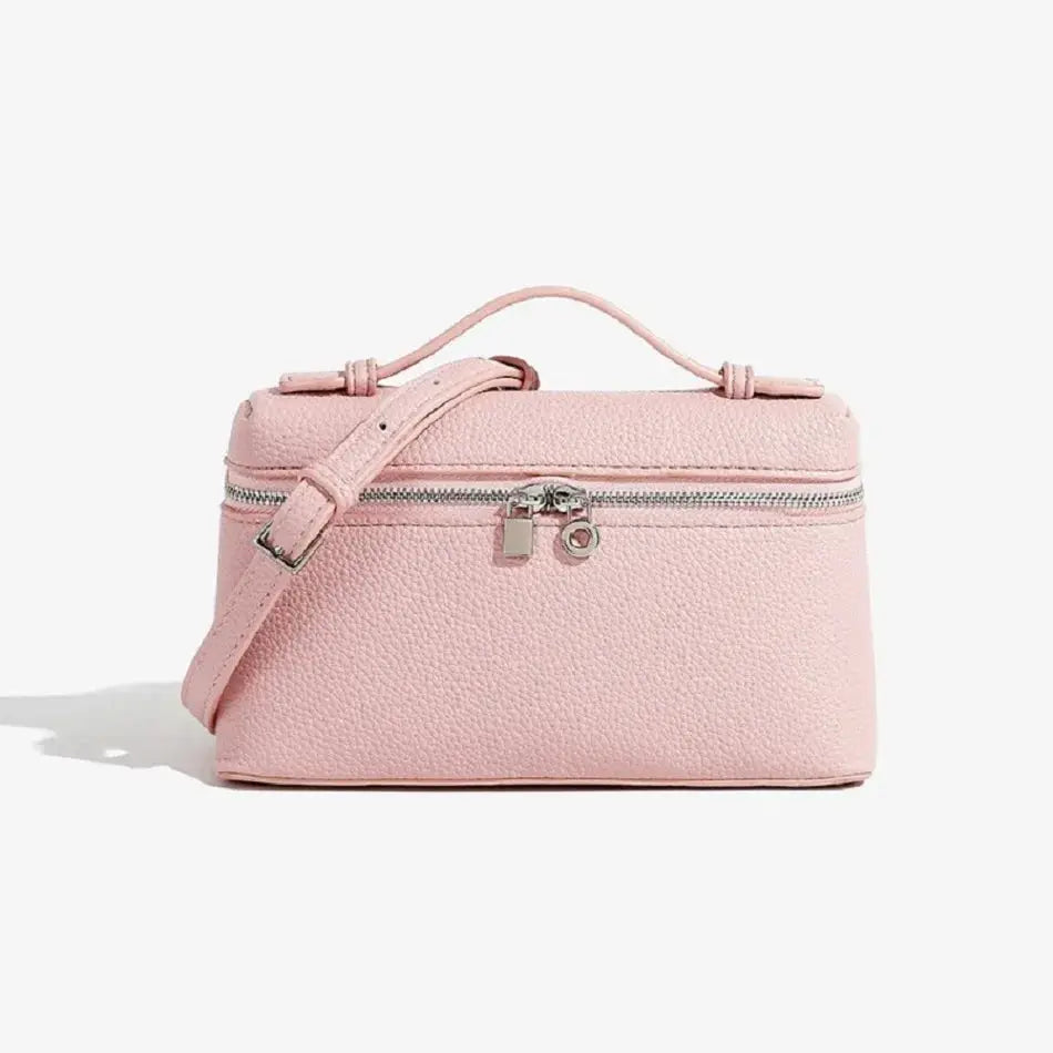 Pink lychee-grain mini shoulder bag with top handle and crossbody strap.