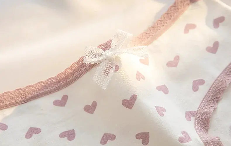 Cotton women's panties set, 5 pieces, pink heart print with pink lace trim and white bow.
