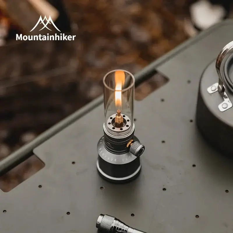 Mountainhiker outdoor gas light set with glass chimney and brass burner on a dark metal base