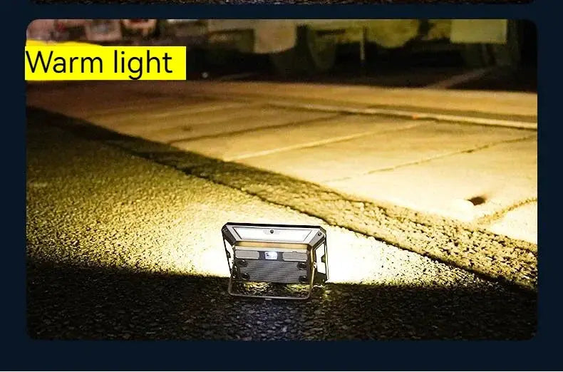 Portable LED camping tent light with warm white beam; rechargeable outdoor searchlight on ground