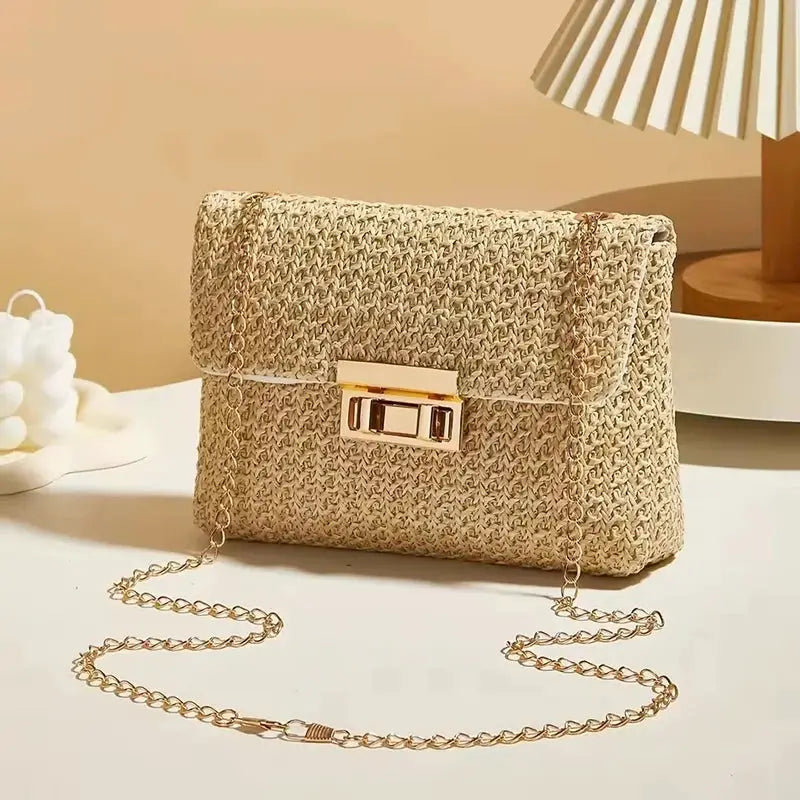 Crossbody bag with beige woven straw texture, gold chain strap, and rectangular clasp.